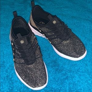 Gold and black tennis shoes